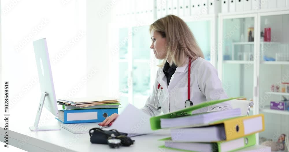 Doctor is working and looking for medical documents in clinic. Medical documents and folders Doctor is working and looking for medical documents in clinic. Medical documents and folders
