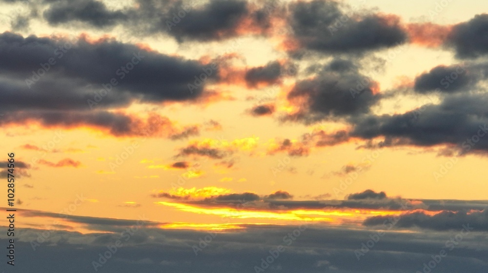 Serene sunset sky with dark clouds and vibrant hues. Serene sunset sky with dark clouds and vibrant hues.