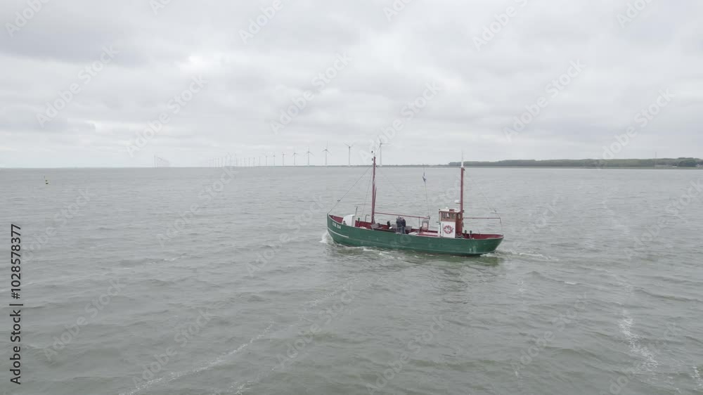 boat in the North Sea with wind turbines and a dam in the Netherlands urk Europe boat in the North Sea with wind turbines and a dam in the Netherlands urk Europe