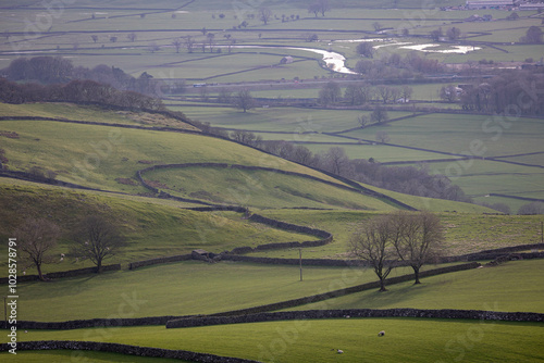 Scenic view of rolling hills and patchwork fields with dry stone walls in Skipton, England. photo