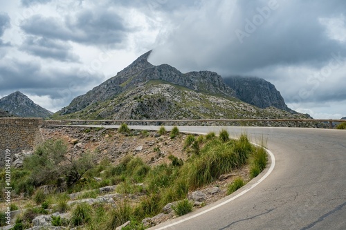 Scenic mountain road with dramatic clouds