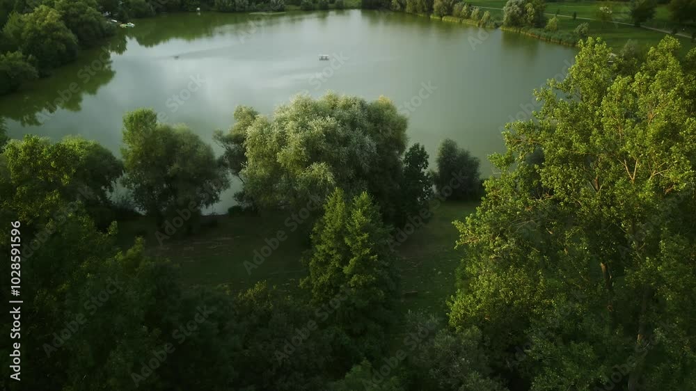 Porstendorf lake surrounded by greens on a sunny morning with houses and hills in the background Porstendorf lake surrounded by greens on a sunny morning with houses and hills in the background