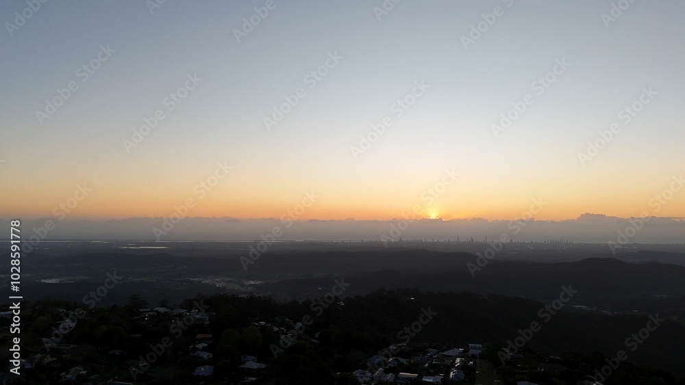 Sunrise over cityscape with clear sky and mountains. Sunrise over cityscape with clear sky and mountains.