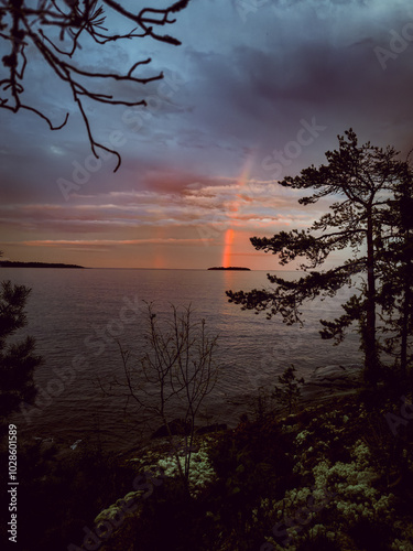 Lake Ladoga at sunset with a rainbow in Karelia.