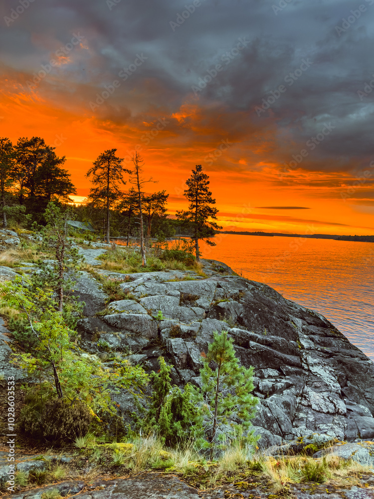 Rocky shore of Lake Ladoga during high tide at sunset Rocky shore of Lake Ladoga during high tide at sunset