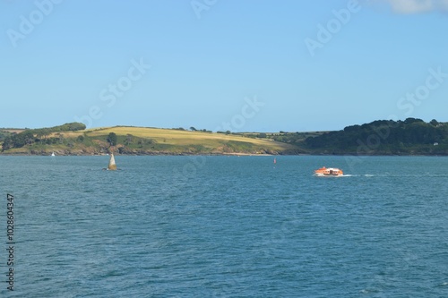 Scenic view of a boat sailing on a calm sea in Falmouth, Cornwall photo