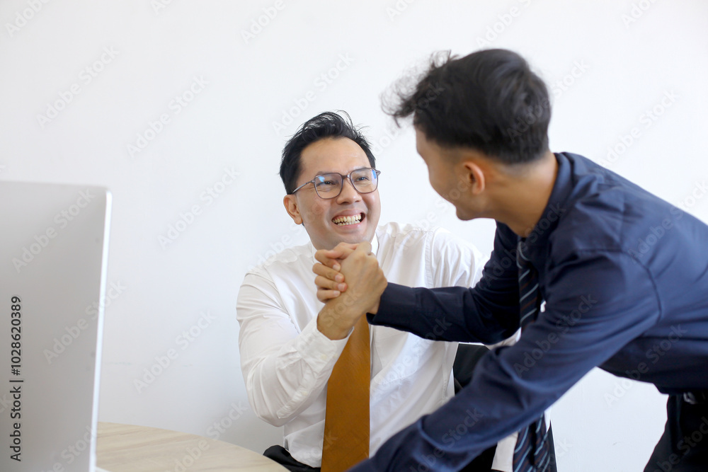 Two Asian Businessmen Shaking Hands at Office. Teamwork Concept Two Asian Businessmen Shaking Hands at Office. Teamwork Concept