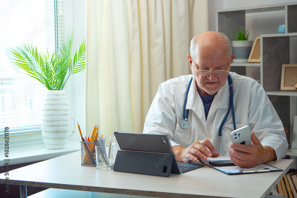 An elderly man, a doctor, in his office, at a table. An elderly man, a doctor, in his office, at a table.