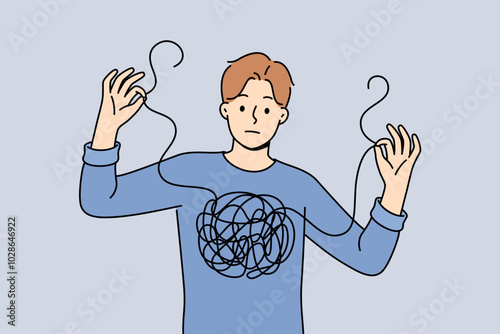 Man confused in himself and in feelings, shows lump of threads in chest and needs help of psychotherapist. Guy confused and cannot independently deal with mental health, suffered due to depression.