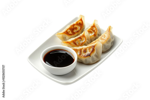 Savory gyoza dumplings with dipping sauce neatly on a transparent background