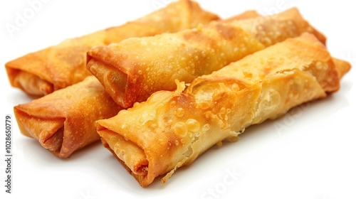 Four golden brown egg rolls, crispy and delicious, isolated on a white background.