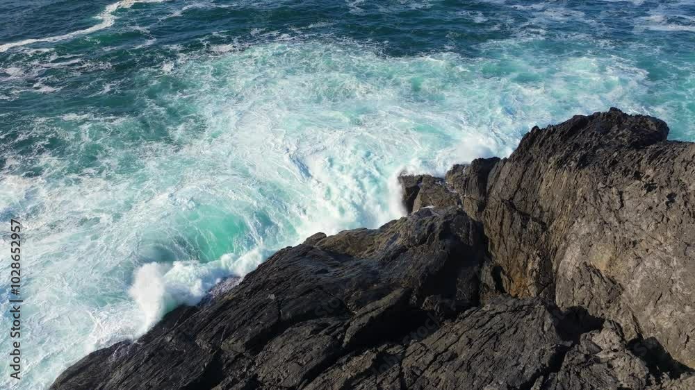 Drone slow-motion of powerful waves breaking into the rocks of Playa Mera in Galicia, Spain Drone slow-motion of powerful waves breaking into the rocks of Playa Mera in Galicia, Spain