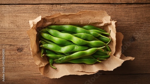 A simple yet aesthetic presentation of fresh green beans arranged in a brown paper package on a rustic wooden surface, evoking freshness and down-to-earth living. photo