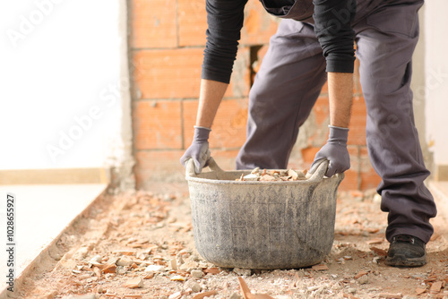 Construction worker ready to lift a full carrycot