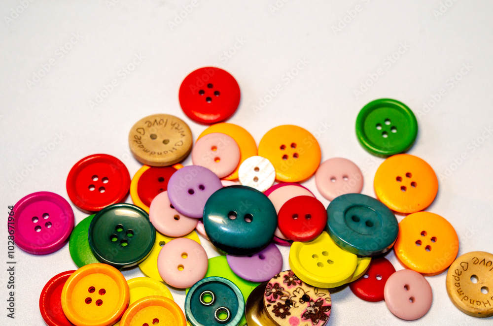 Chaotic collection of coloured buttons on a white background Chaotic collection of coloured buttons on a white background