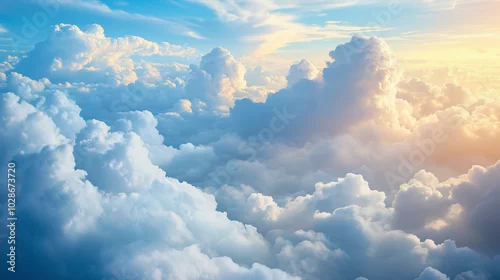 Obraz Z okna samolotu rozpościera się zapierający dech w piersiach widok na chmury, które przypominają puchate poduszki unoszące się w błękicie nieba.