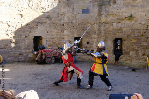 Two medieval knights cosplay a duel in castle