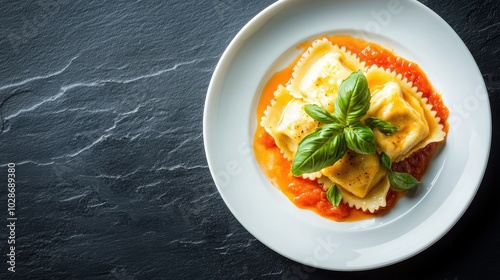 Delicious Ravioli in Tomato Sauce Garnished with Basil photo