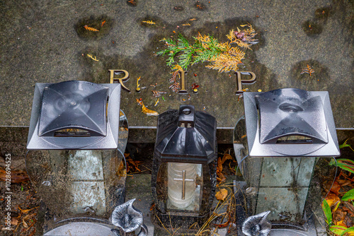 unmarked grave in the cemetery without a plaque. grave without a name. inscription rip, rest in peace. candles on the grave on All Saints' Day. photo