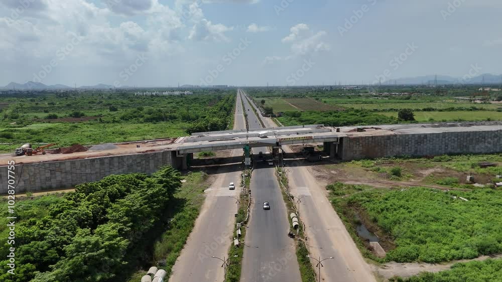 Aerial view of rural Amaravathi’s green fields, intersected by a major highway. Aerial view of rural Amaravathi’s green fields, intersected by a major highway.