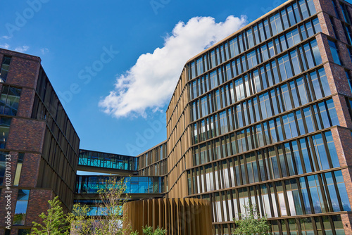 Photography Contemporary office buildings with glass facades connected by skybridge