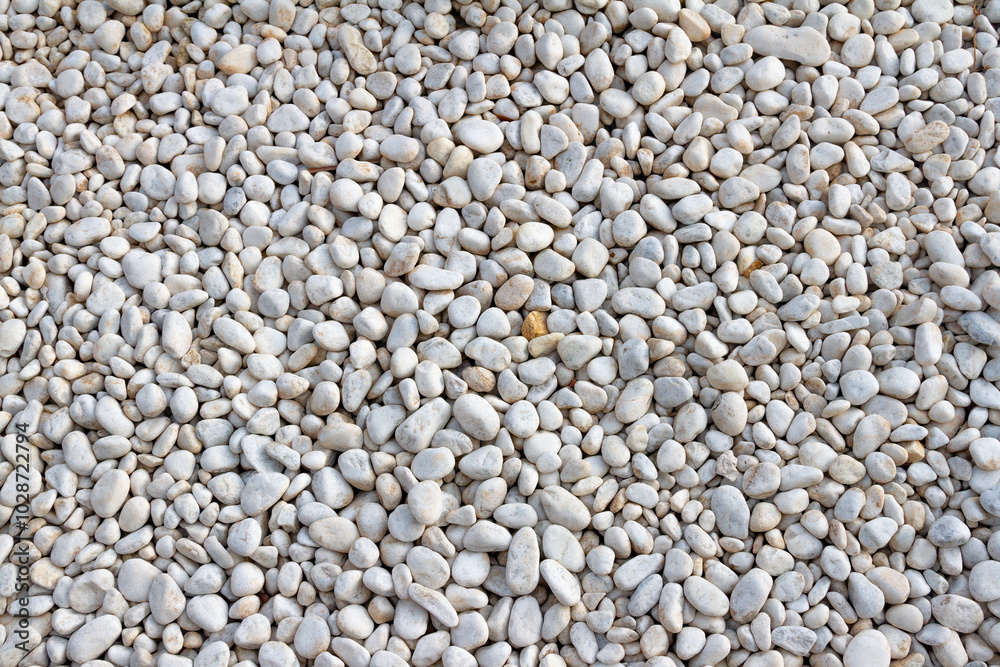 White pebble stones background texture. Close up of stone pebbles. White pebble stones background texture. Close up of stone pebbles.