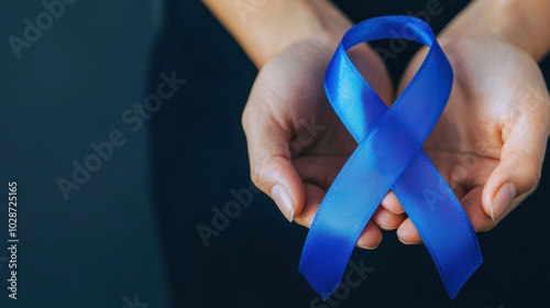 Obraz na płótnie Hands holding blue awareness ribbon symbolizing support for diabetes awareness. This conveys message of hope and solidarity in fight against diabetes w salonie