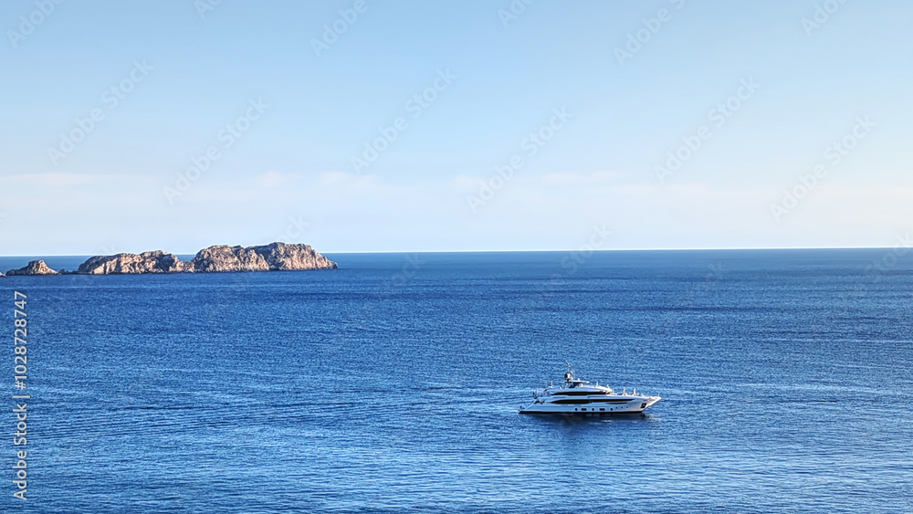 Yacht on sea bay on sunset, horizontal skyline view, top side aerial view, Majorca island, Spain Yacht on sea bay on sunset, horizontal skyline view, top side aerial view, Majorca island, Spain