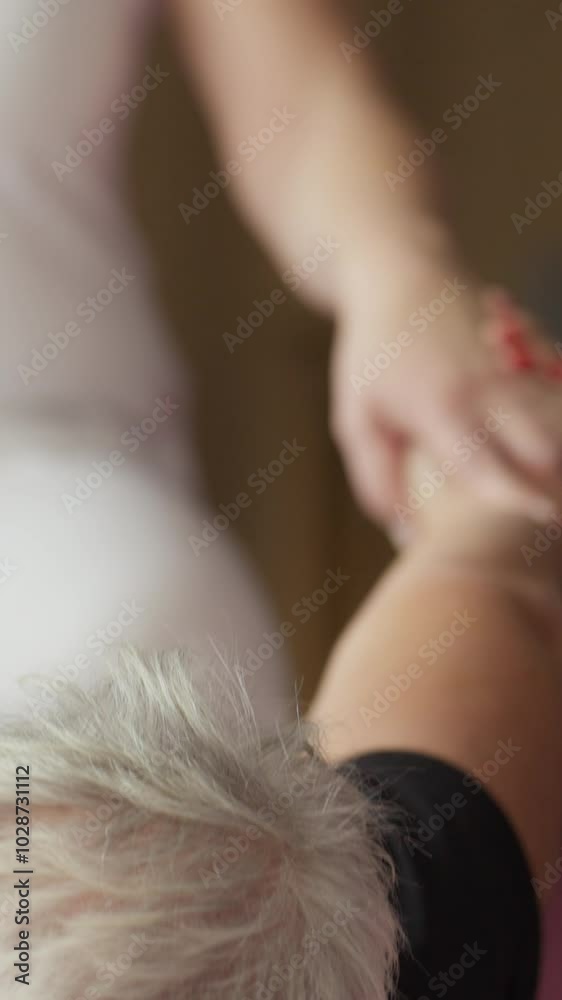 Vertical Screen: Physical Therapist Pulling Senior Woman's Hands to Stretch Her Back. Concept of Physiotherapy, Relief, Treatment, Wellness, Rehabilitation, Recovery, Training, Exercise, Flexibility Vertical Screen: Physical Therapist Pulling Senior Woman's Hands to Stretch Her Back. Concept of Physiotherapy, Relief, Treatment, Wellness, Rehabilitation, Recovery, Training, Exercise, Flexibility