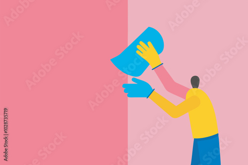 Man in yellow top and blue gloves cleans pink wall with cloth, left hand supports right hand.