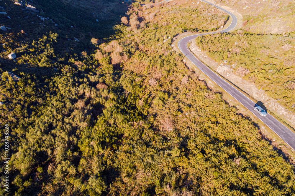 Fototapeta premium mountain road seen from a drone at sunset, aerial image. Fall season