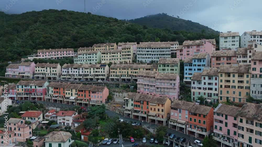 Colorful hillside buildings in an Italian town with lush greenery and cloudy skies Colorful hillside buildings in an Italian town with lush greenery and cloudy skies
