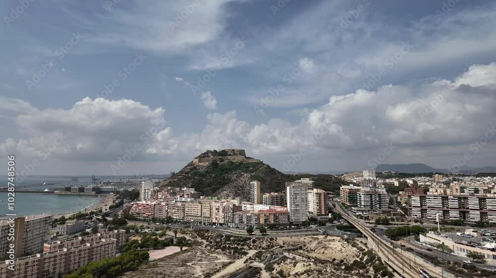 Elevated view of Alicante City, Spain. Fixed camera time lapse with a view of city Center, Castle and Mediterranean Sea. Sunny summer day with some clouds in a changing sky. 4K Elevated view of Alicante City, Spain. Fixed camera time lapse with a view of city Center, Castle and Mediterranean Sea. Sunny summer day with some clouds in a changing sky. 4K