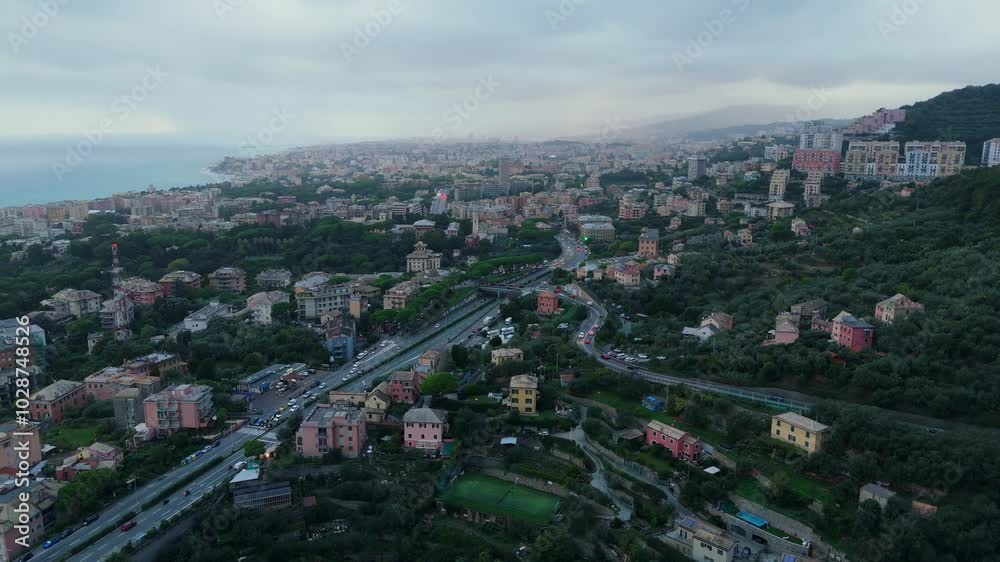A coastal italian town surrounded by greenery under an overcast sky at dusk, aerial view A coastal italian town surrounded by greenery under an overcast sky at dusk, aerial view