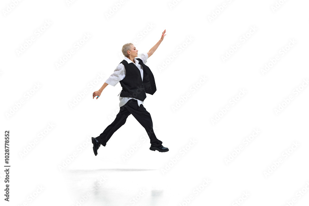 Casually dressed young woman jumps forward with determined look, showing individuality and creativity against white studio background. Concept of DEI, business, partnership, work, support and unity. Casually dressed young woman jumps forward with determined look, showing individuality and creativity against white studio background. Concept of DEI, business, partnership, work, support and unity.
