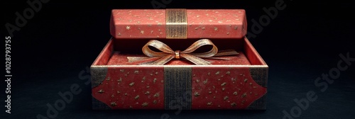 A beautifully wrapped red gift box with a golden bow glowing against a dark b...