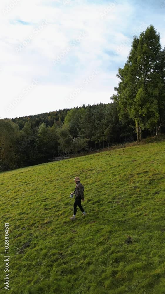 walking in the grass, walking in the mountains, a traveler walks through a green field in the mountains at dawn, Aerial footage of a drone walking in the grass, walking in the mountains, a traveler walks through a green field in the mountains at dawn, Aerial footage of a drone