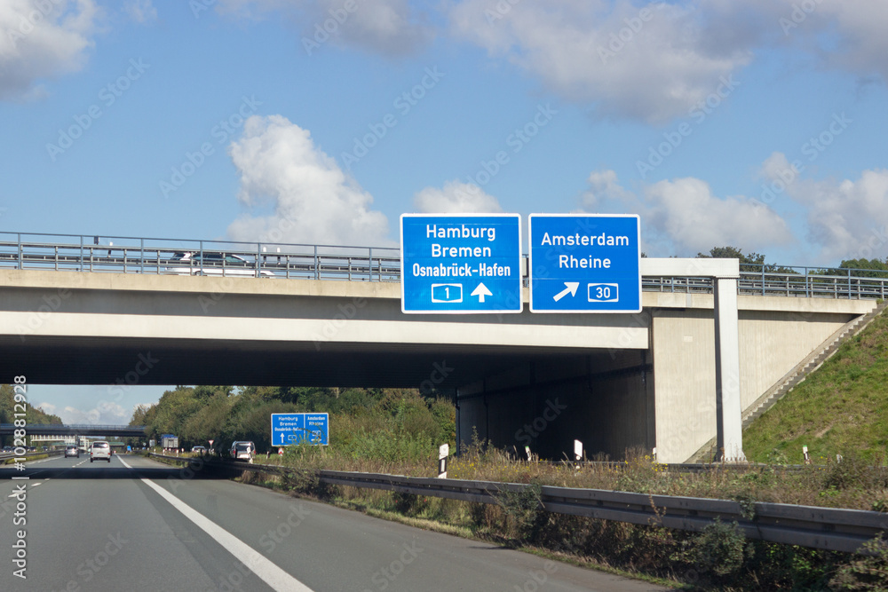 Obraz premium Verkehrswegweiser auf Autobahn A1, am Kreuz Lotte/Osnabrück in Richtung Bremen, Hamburg, Osnabrück-Hafen, Amsterdam, Rheine