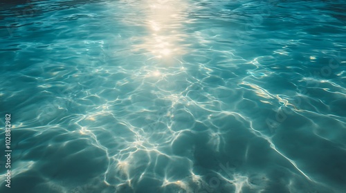 Gentle ripples shimmer across the crystal-clear ocean water at sunset background