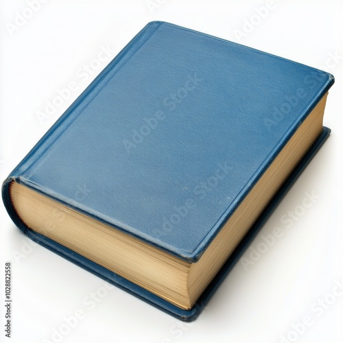 A closed blue fabric covered book lying on a white surface under soft lighting