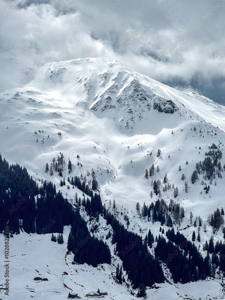 Scenic view of snow covered mountain in the ski region of Saalbach-Hinterglemm in the Austrian alps against cloudy sky