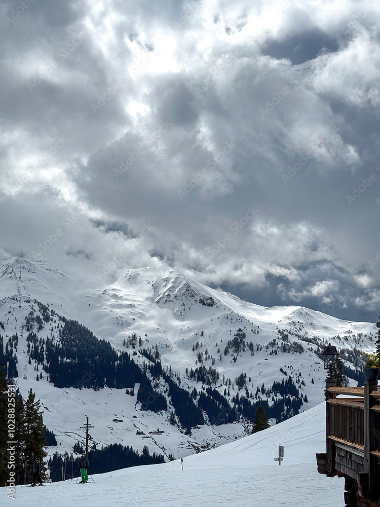 Scenic view of snow covered mountains in the ski region of Saalbach-Hinterglemm in the Austria alps against cloudy sky