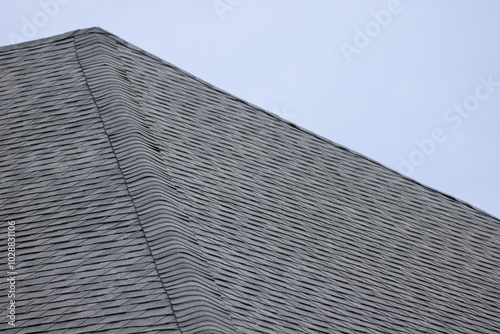 roof shingle background and texture. dark asphalt tiles on the roof.