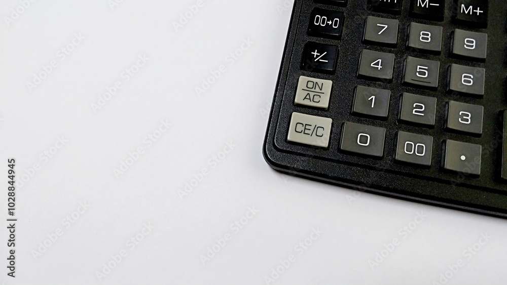a partial view of a calculator on a white surface. Only the right side of the calculator is visible, displaying several buttons. The visible buttons include 