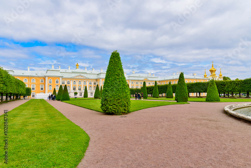 Summer Palace, Saint Petersburg, Russia - July 20, 2019: Tourists are walking through the beautifully decorated gardens.
 photo