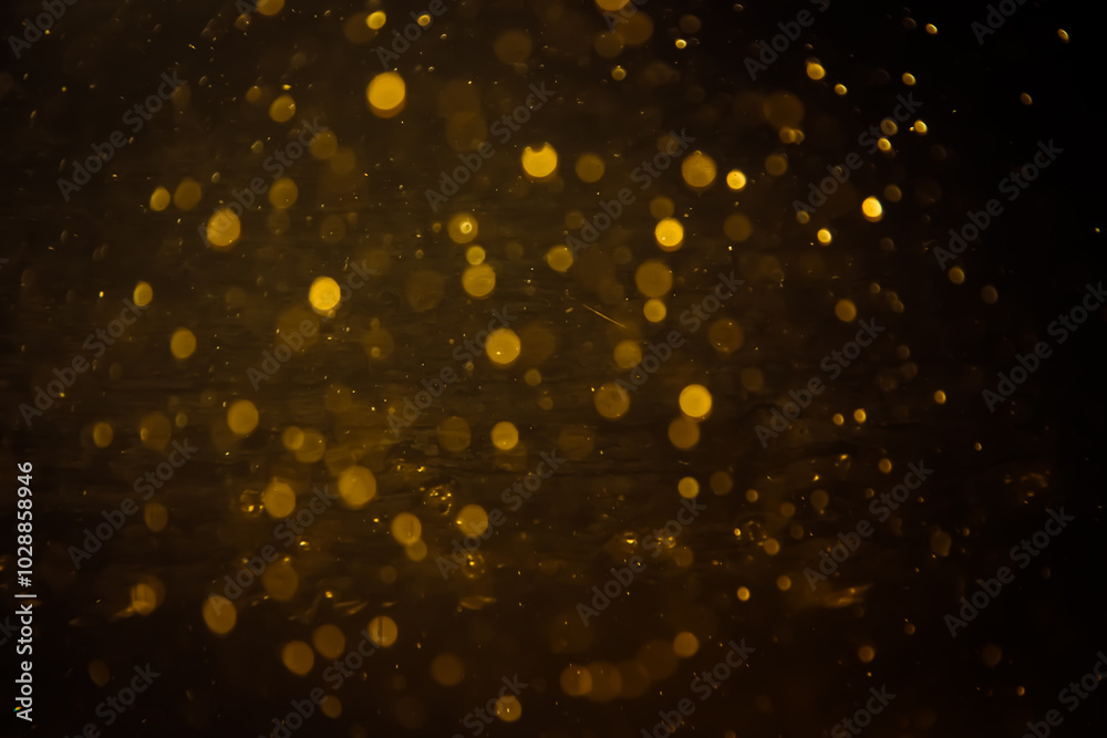 Blurred photo with golden dots visible glittering, shining brightly look and feel luxurious Suitable for use as a wallpaper Blurred photo with golden dots visible glittering, shining brightly look and feel luxurious Suitable for use as a wallpaper