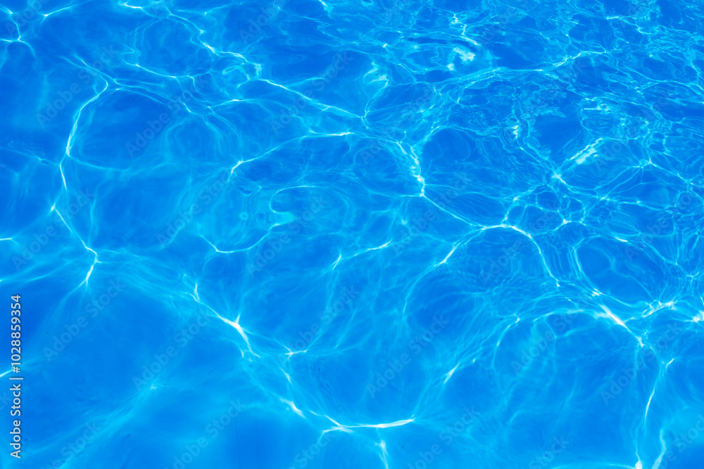 Clear blue swimming pool water surface with sunlight reflections creating abstract patterns and ripples, evoking a refreshing and tranquil summer vibe. Clear blue swimming pool water surface with sunlight reflections creating abstract patterns and ripples, evoking a refreshing and tranquil summer vibe.
