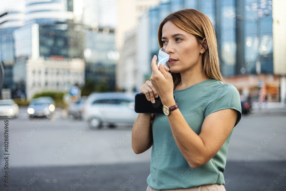 Portrait of a beautiful Caucasian woman wearing a protective face mask. Portrait of a young attractive Caucasian woman standing outdoors and smiling while putting on a protective face mask. Portrait of a beautiful Caucasian woman wearing a protective face mask. Portrait of a young attractive Caucasian woman standing outdoors and smiling while putting on a protective face mask.