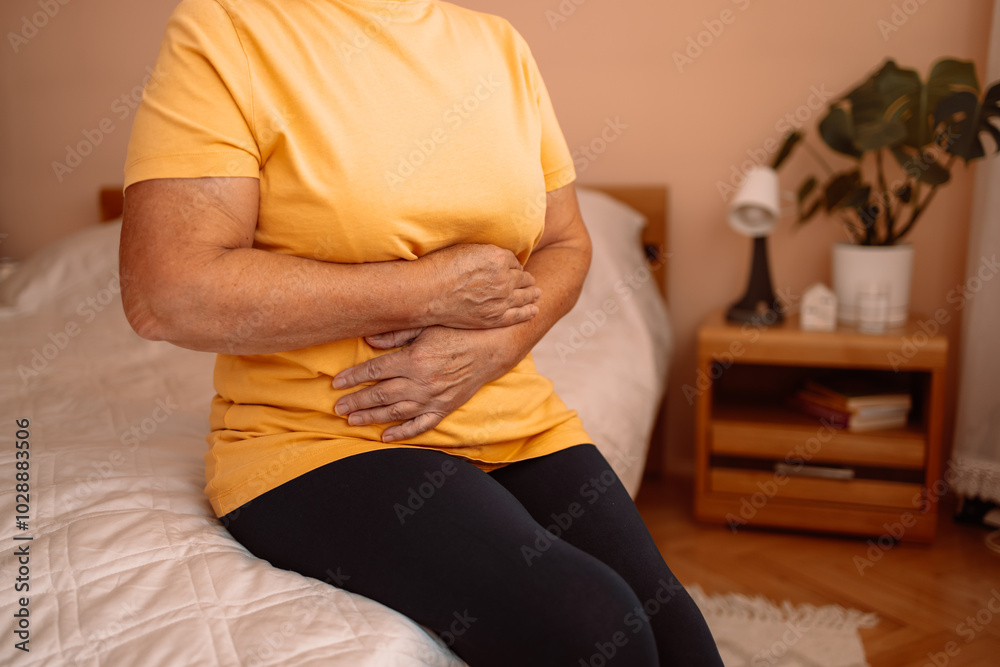 Abdominal pain in elder senior mature aging woman with stomachache illness from stomach cancer, irritable bowel syndrome, Indigestion, Diarrhea, gastroparesis or GERD