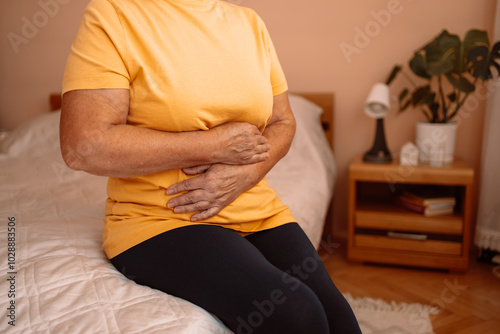 Obraz na płótnie Abdominal pain in elder senior mature aging woman with stomachache illness from stomach cancer, irritable bowel syndrome, Indigestion, Diarrhea, gastroparesis or GERD w salonie